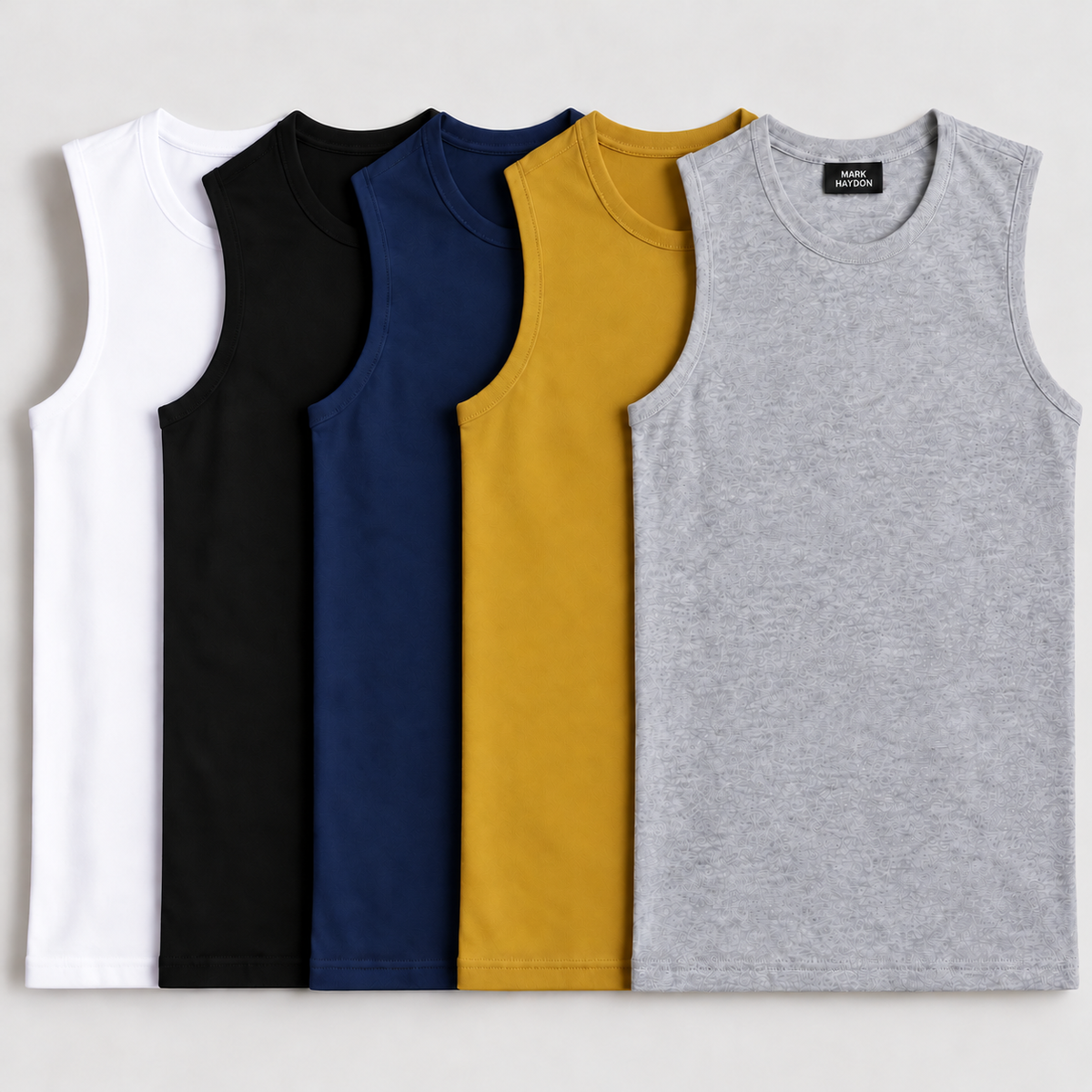 Five sandos in grey, mustard yellow, navy blue, black and white with MARK HAYDON label on front grey sando